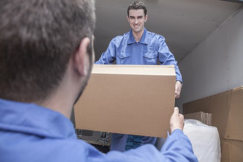 Person loading moving boxes with a Queenspark man and van service