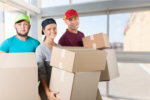 Professional movers handling business equipment during a Queenspark move