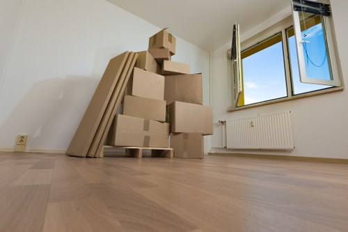Packed moving boxes and furniture prepared for Queenspark removals