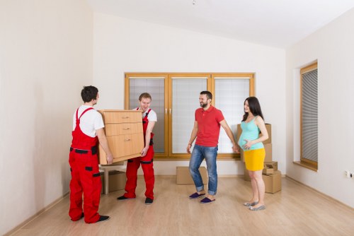 Packed boxes and removal van loading during a Queens Park relocation