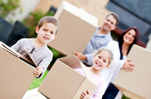 Local moving team handling furniture on a Queens Park street