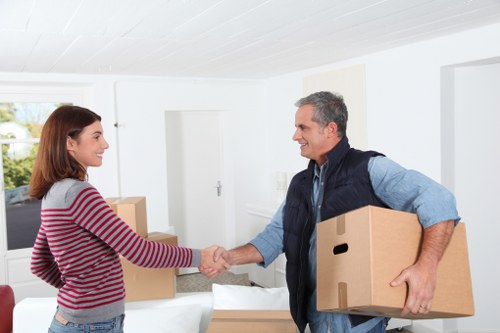 Local house removalists in Queenspark carrying furniture through a home
