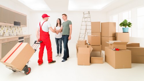 Packing and loading household items into a moving truck in Queens Park